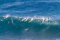 Waimea bay Oahu Hawaii, Surfers ride a big wave Royalty Free Stock Photo