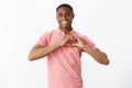 Wais-up shot of sincere kind and cute african american young male sharing love and tender feelings showing heart gesture