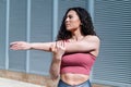 Waist portrait of healthy young woman warming up outside