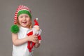 happy little girl laughing, holding knitted Santa Claus toy in her hands, concept happy family, childhood, Christmas Royalty Free Stock Photo