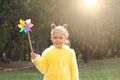 Beautiful child with pinwheel in park