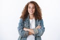 Waist-up confident professional good-looking smiling curly-haired chubby woman denim jacket cross hands chest self