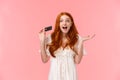 Waist-up portrait amused, wondered and excited fashionable feminine redhead girl telling about great promos and bonuses