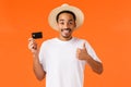 Waist-up portrait attractive smiling african american male tourist using bank service abroad, showing thumb-up and Royalty Free Stock Photo