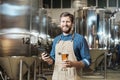 Brewmaster holding beer glass Royalty Free Stock Photo