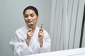 Pleased woman preparing for a facial massage