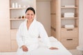 Happy woman having rest on massage table at spa Royalty Free Stock Photo