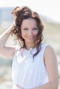 Portrait of girl in white dress with hand in hair Royalty Free Stock Photo