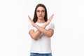 Waist-up portrait of determined, serious-looking young female activist, saying no to women opression, show cross sign in Royalty Free Stock Photo