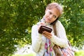 Portrait of focused girl speaking by phone and writing some info Royalty Free Stock Photo