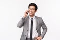 Waist-up portrait of good-looking, confident and stylish asian young businessman calling person on phone, having Royalty Free Stock Photo