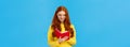 Waist-up portrait redhead female student write down thoughts in red lovely notebook, prepare grocery list, make schedule