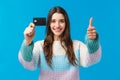 Waist-up portrait satisfied young woman smiling recommend bank, received her scholarship, show thumb-up, credit card Royalty Free Stock Photo