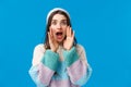 Waist-up portrait silly, cute feminine young woman in winter hat, sweater, calling for someone, shouting with hands near Royalty Free Stock Photo