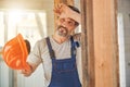 Smiling man in overalls holding his helmet Royalty Free Stock Photo