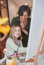 Girl looking to the camera while creating masterpiece at home with her granny Royalty Free Stock Photo