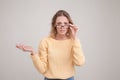 Waist-up portrait of young blond woman with surprised emotion on her face. looking at the camera, notices something unexpected, Royalty Free Stock Photo