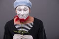 Waist-up portrait of young male mime holding a Royalty Free Stock Photo