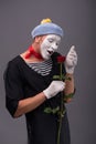 Waist-up portrait of young male mime holding a Royalty Free Stock Photo