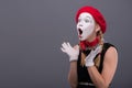 Waist-up portrait of young mime girl showing Royalty Free Stock Photo