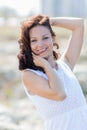 Waist up portrait of young woman in white sleeveless dress Royalty Free Stock Photo