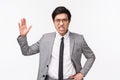 Waist-up potrait of angry, outraged asian businessman scolding employees, shouting and raising hand aggressive