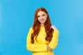 Waist-up shot attractive flirty redhead modern girl millennial in yellow sweater, playing with hair and smiling lovely