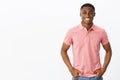 Waist-up shot of attractive positive and happy young african american male entrepreneur in pink polo shirt holding hands