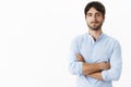 Waist-up shot of confident successful handsome entrepreneur with blue eyes and bristle in blue shirt holding hands