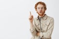Waist-up shot of creative redhead male genius with wavy hair and beard adding great suggestion standing in eureka pose