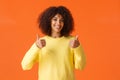 Waist-up shot cute supportive african-american woman feeling happy about great idea, shot thumb-up and smiling, agree Royalty Free Stock Photo