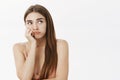 Waist-up shot of gloomy and moody upset young female student with beautiful long brown hair leaning head on hand and Royalty Free Stock Photo