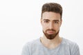 Waist-up shot of handsome sensual and confident young man with beard, moustache and blue eyes smiling looking sincere Royalty Free Stock Photo