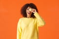 Waist-up shot happy cute african-american female eating sweets, holding tasty little macaron over face and smiling, like Royalty Free Stock Photo