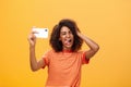 Waist-up shot of stylish confident african american woman with afro hairstyle in trendy t-shirt taking selfie on awesome