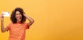 Waist-up shot of stylish confident african american woman with afro hairstyle in trendy t-shirt taking selfie on awesome