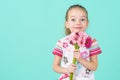 Waist up studio portrait of an adorable little girl holding bouquet of pink gerbera daisies. Happy Mother`s Day, Women`s day. Royalty Free Stock Photo