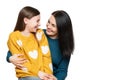 Waist up studio portrait of a mother and young daughter face to face laughing. Happy family laughing background. Royalty Free Stock Photo