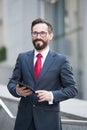 Waist up of successful banker with a tablet in hand