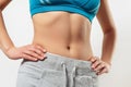 Waist of a young woman in sportswear. on white background