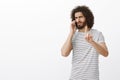 Wait second, it is importrant call. Bossy masculine attractive man with beard and afro hairstyle, showing index finger Royalty Free Stock Photo