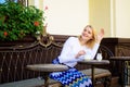 Wait for waitress. Woman sits cafe terrace urban background defocused. Girl cafe drink coffee waiting waitress Royalty Free Stock Photo