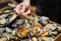 waiter adding sauce on mussels