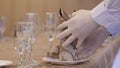 A waiter arranges the napkin on the plate