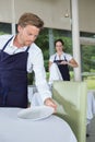 Waiter arranging place settings on table Royalty Free Stock Photo