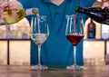 Bartender pouring two glasses of wine simultaneously. Royalty Free Stock Photo