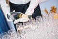 Waiter bartender pouring wine at party