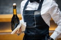 Waiter in a restaurant with a bottle of prosecco Royalty Free Stock Photo