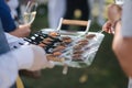 Waiter bring portioned salmon and beef tartare on a tray