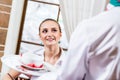 Waiter brings a dish for a nice woman Royalty Free Stock Photo